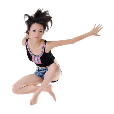 Modern style dancer jumping on white studio background.の写真素材