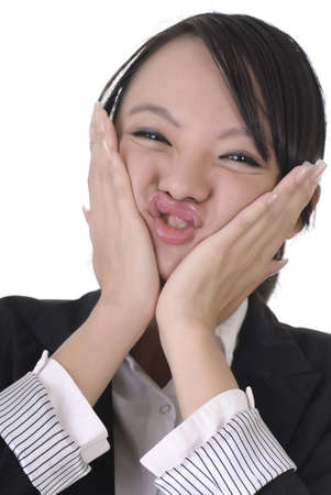 Young business woman with wry face on white background.の写真素材
