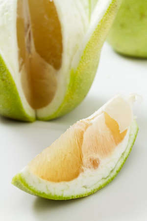 Fresh pomelo fruit peeled on white background.の写真素材