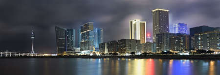 Panoramic cityscape in night with skyscraper and buildings and river in Macao, China.の写真素材