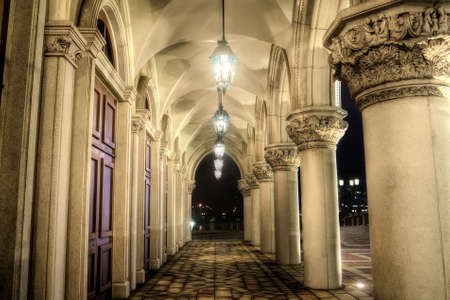 Old corridor in yellow color with lamp in night.の写真素材