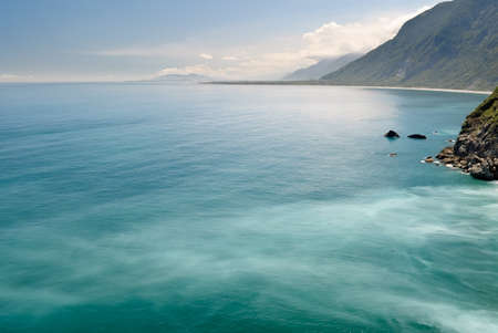 Seascape of cliff with beautiful ocean under blue sky.の写真素材