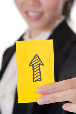 Up arrow on business card holding by Asian businesswoman.の写真素材
