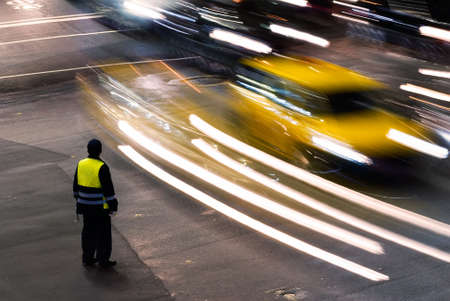 Policeman working at night in the traffic road with cars light in Taiwan, Asia.の写真素材