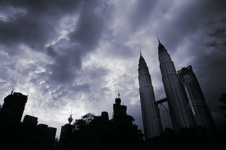 City silhouette with high buildings and skyscrapers under dramatic clouds in Kuala Lumpur, Malaysia, Asia.のeditorial素材