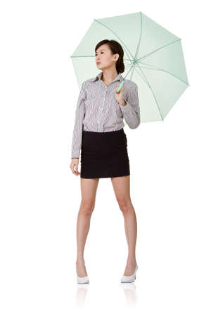 Business woman holding umbrella of green, isolated on white background.の写真素材