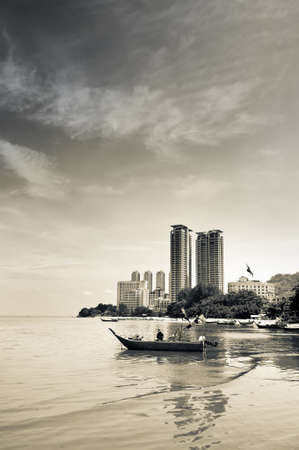 Bay in city with boats and skyscraper under dramatic sky.の写真素材