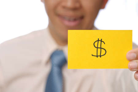 Money shape on yellow card holding by business man, closeup image.の写真素材