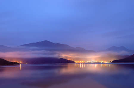 Lake with mist in morning with blue color, Taiwan famous attraction, Sun Moon Lake situated in Yuchi, Nantou, Taiwan, Asia.の写真素材