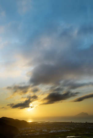 Sunrise with dramatic clouds on sky over ocean and farm in Lanyang Plain, Yilan, Taiwan, Asia.の写真素材