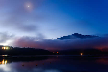 Moon night lake landscape with mist, Taiwan famous attraction, Sun Moon Lake situated in Yuchi, Nantou, Taiwan, Asia. The lake and its surrounding countryside have been designated one of thirteen National scenic areas in Taiwan.の写真素材