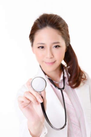 Friendly Asian doctor woman use stethoscope, closeup portrait focus on  stethoscope and isolated on white background.の写真素材