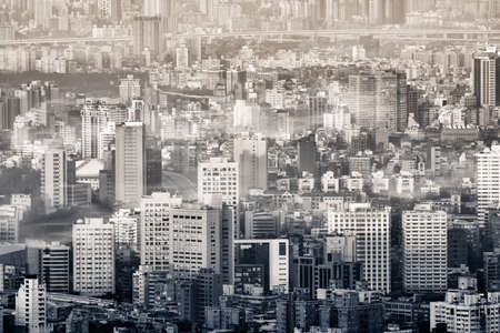 Mist city scenery with fogs over modern buildings at morning in Taipei, Taiwan.の写真素材
