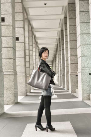 Asian mature woman at street, full length portrait.の写真素材