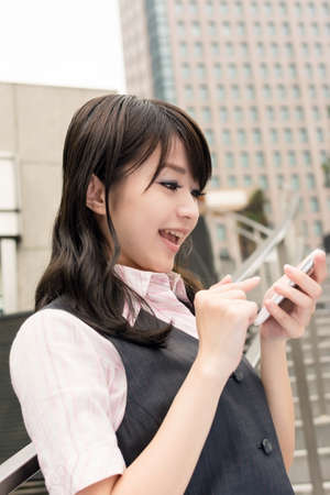 Business woman use smartphone in outside of modern city.の写真素材