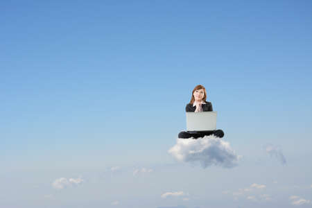 Business woman sit on cloud and use laptop over sky.