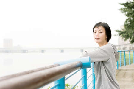 Portrait of sport mature Asian woman in outdoor in daytime.の写真素材