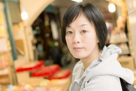 Mature Asian women in sport dress walk at modern street in Taipei, Taiwan, Asia.の写真素材