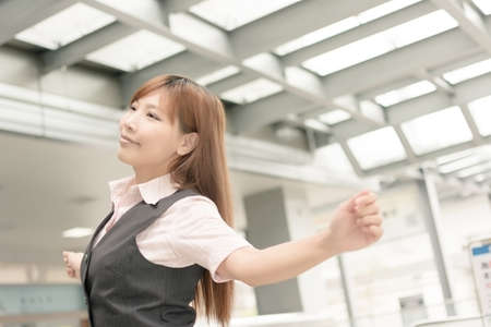 Relaxed Asian business woman raising arms, closeup portrait in outside , Taipei, Taiwan, Asia.の写真素材