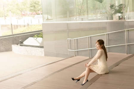 Asian beauty sit on ground and look far away in Taipei, Taiwan, Asia.の写真素材