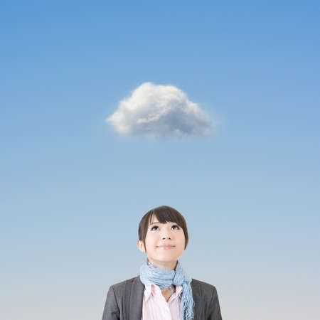 Charming asian business woman looking up on a thoughful cloud.の写真素材