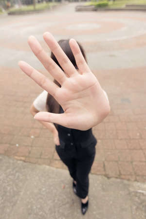 Asian business woman give you a big stop gesture in outside.の写真素材