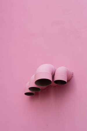 Pink pipes on wall of a buildingの写真素材