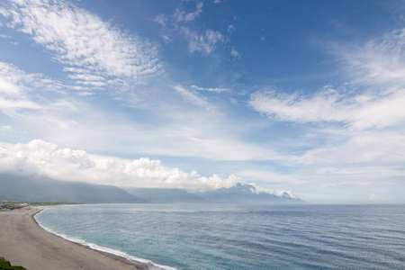 Beautiful seascape with shoreline and mountain in the distance. Shot at Qixingtan Beach in Hualien, Taiwan, Asia.の写真素材