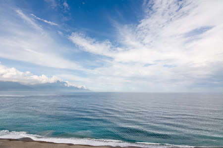 Beautiful seascape with shoreline and mountain in the distance. Shot at Qixingtan Beach in Hualien, Taiwan, Asia.の写真素材