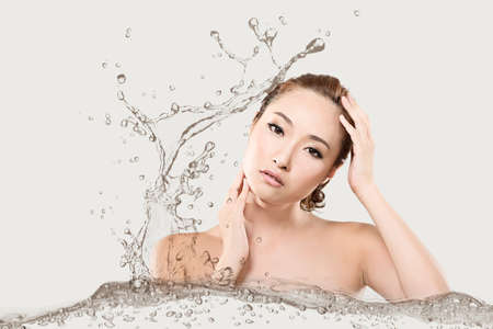 Asian beauty face with water, closeup portrait with clean and fresh elegant lady.の写真素材