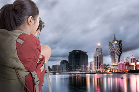 Young backpacker travel and take picture at Macau with famous casino skyscrapers のeditorial素材