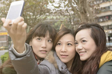 Asian women take picture by themselves.の写真素材