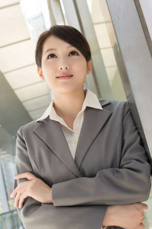 Portrait of attractive Asian business woman at modern building in Taipei, Taiwanの写真素材
