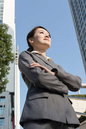 Confident Asian business woman standing in outside of office in sunny day in Taipei, Taiwan, Asia.の写真素材