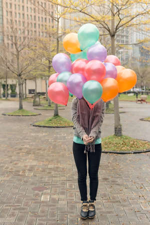Woman hold balloons at street, Taipei, taiwan, Asia.の写真素材