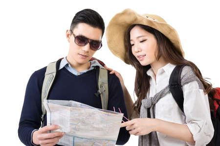 Young Asian couple travelers looking the map, closeup portrait on white background.の写真素材
