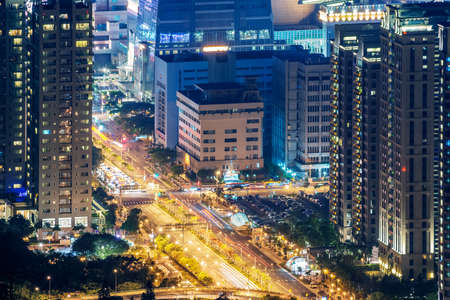 Modern city night with skyscrapers and cars light at road in Taipei, Taiwan, Asia.の写真素材