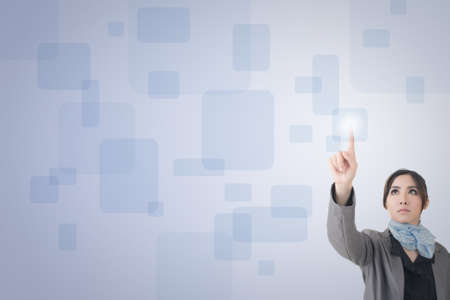 Asian business woman pushing touch screen button.