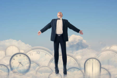 Asian businessman fly over clocks, concept of time management, success, free etc.の写真素材