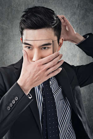Asian business man in mask, concept of hide, cheat, lie etc.の写真素材
