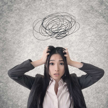 Confused Asian business woman. Photo compilation with hand drawn background.の写真素材