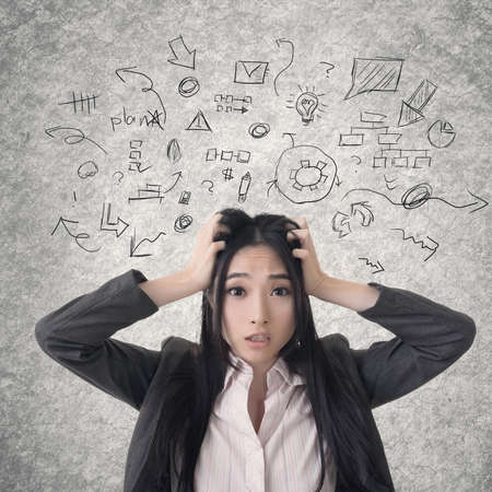 Confused Asian business woman. Photo compilation with hand drawn background.の写真素材