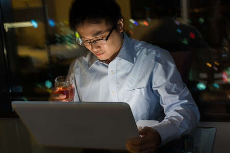Asian man work at night in the office.の写真素材