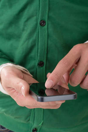 Closeup image of man using cellphone on white background.