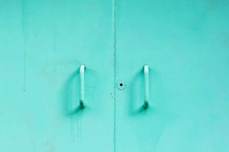 Old metal door with a keyhole, closed.の写真素材