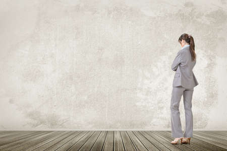 One business executive lowered head and contemplate, rear view of full length portrait.の写真素材