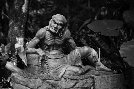 Old ruined Arhat Kanakbharadvaja statue in forest, Taiwan, Asia.の写真素材