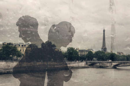 Glass reflection of Asian couple back to back and thinking.の写真素材