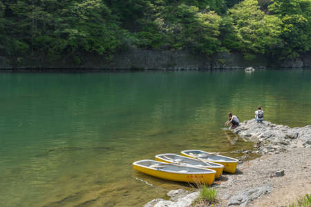 KYOTO, JAPAN - APRIL 26th  : Three canoes docked at the shore of Hozu(Katsuragawa)  River in Arashiyama in Kyoto, Japan on 26th April 2014.のeditorial素材