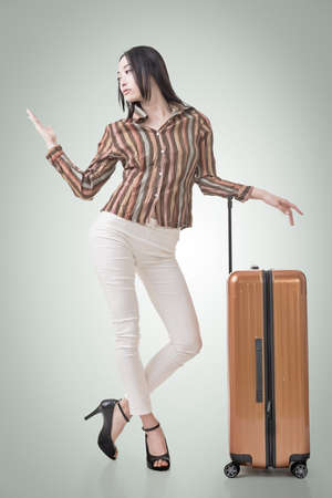 Modern Asian woman stand with a luggage in vintage style.の写真素材